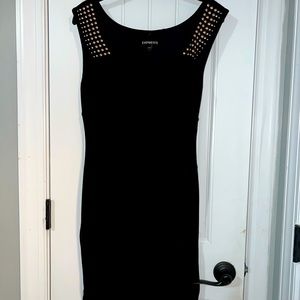 Black sleeveless dress with rose gold detail.